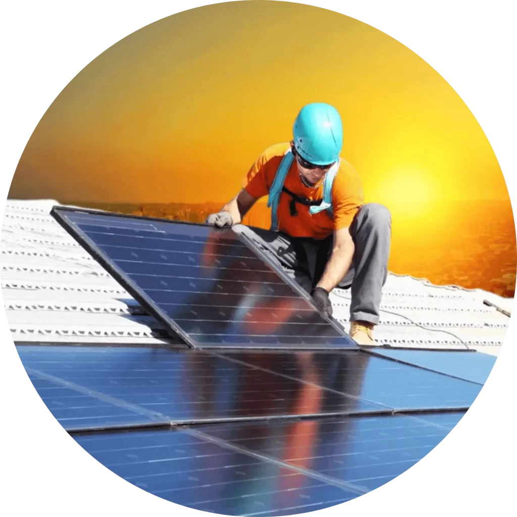 Man installing a solar panel on a rooftop with the sun behind